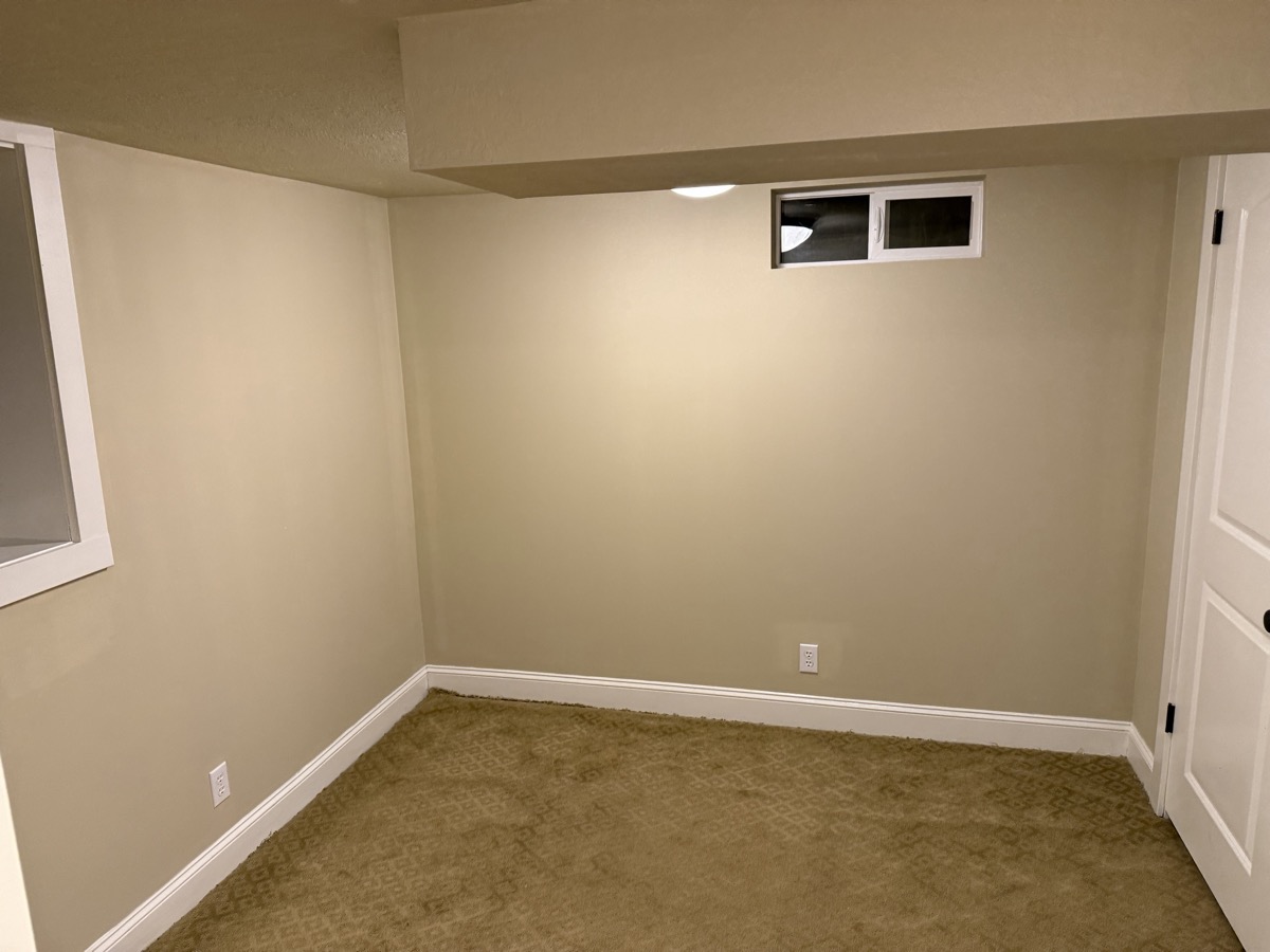 Basement after — fresh beige walls, crisp white trim