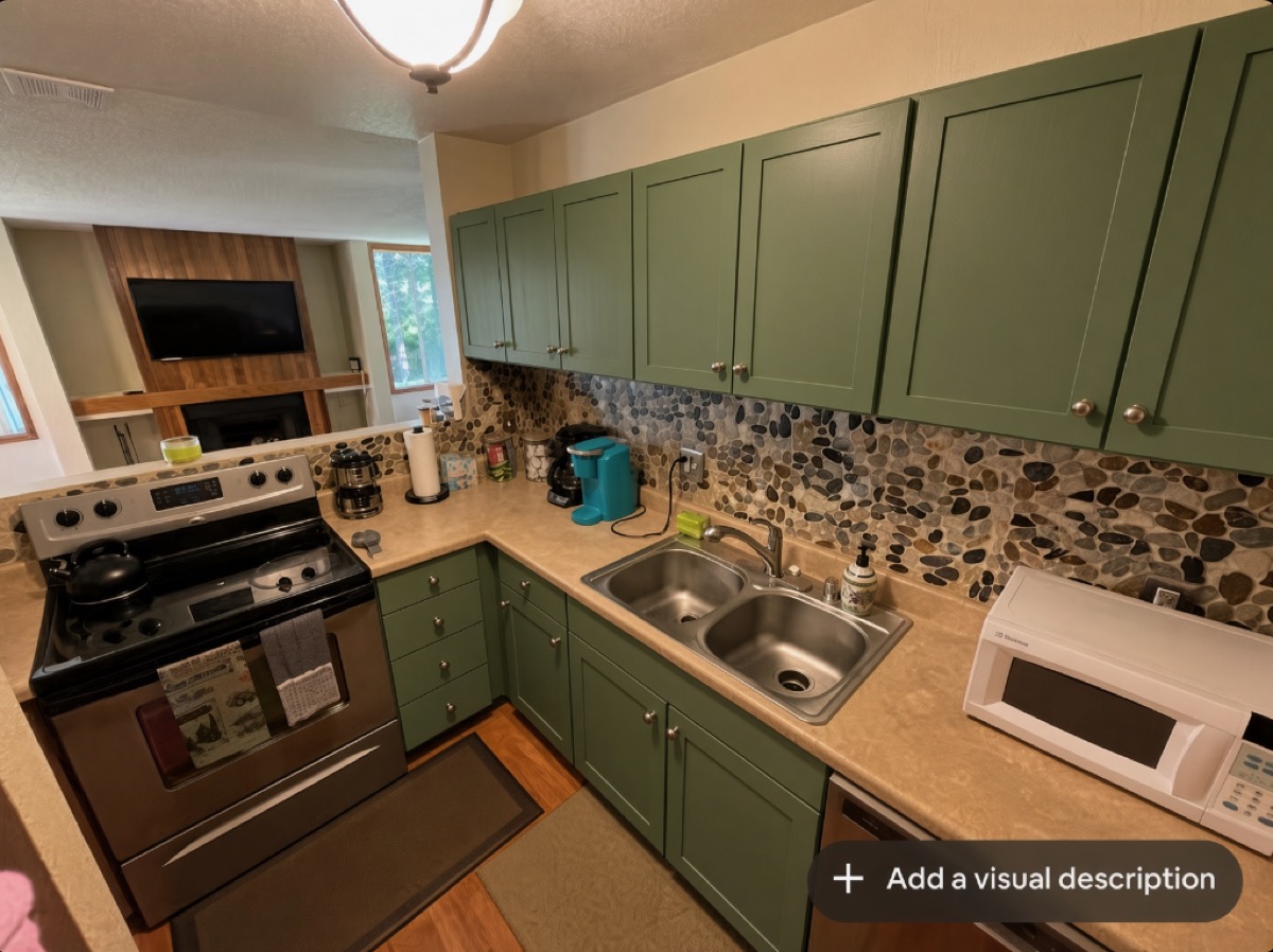 Kitchen after — sage green cabinet refinish