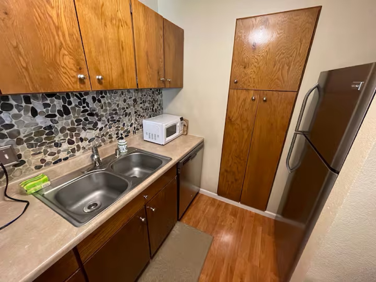 Kitchen before — dated cabinets