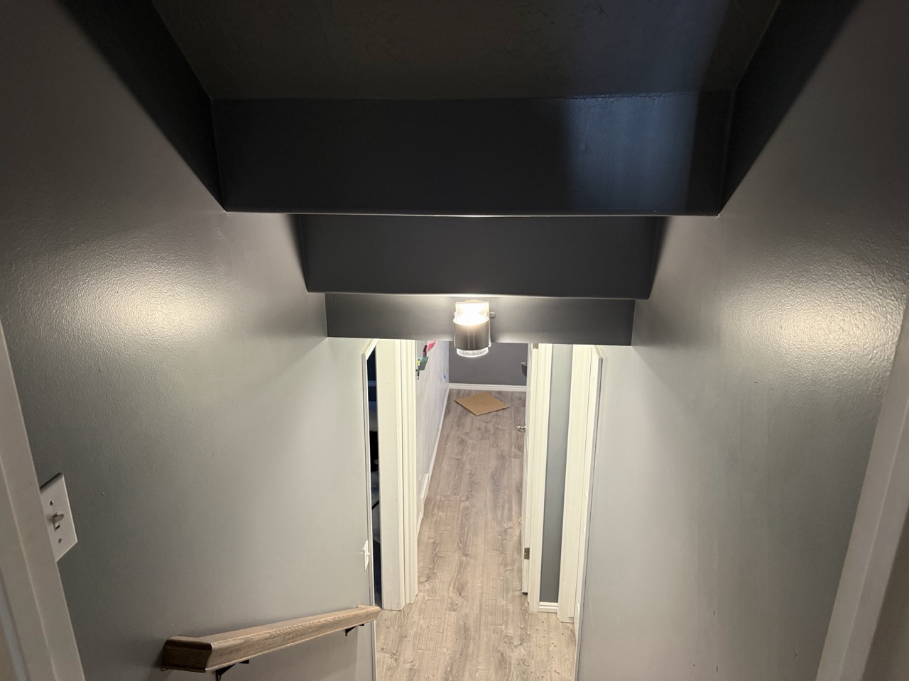 Hallway with freshly painted charcoal walls and white trim
